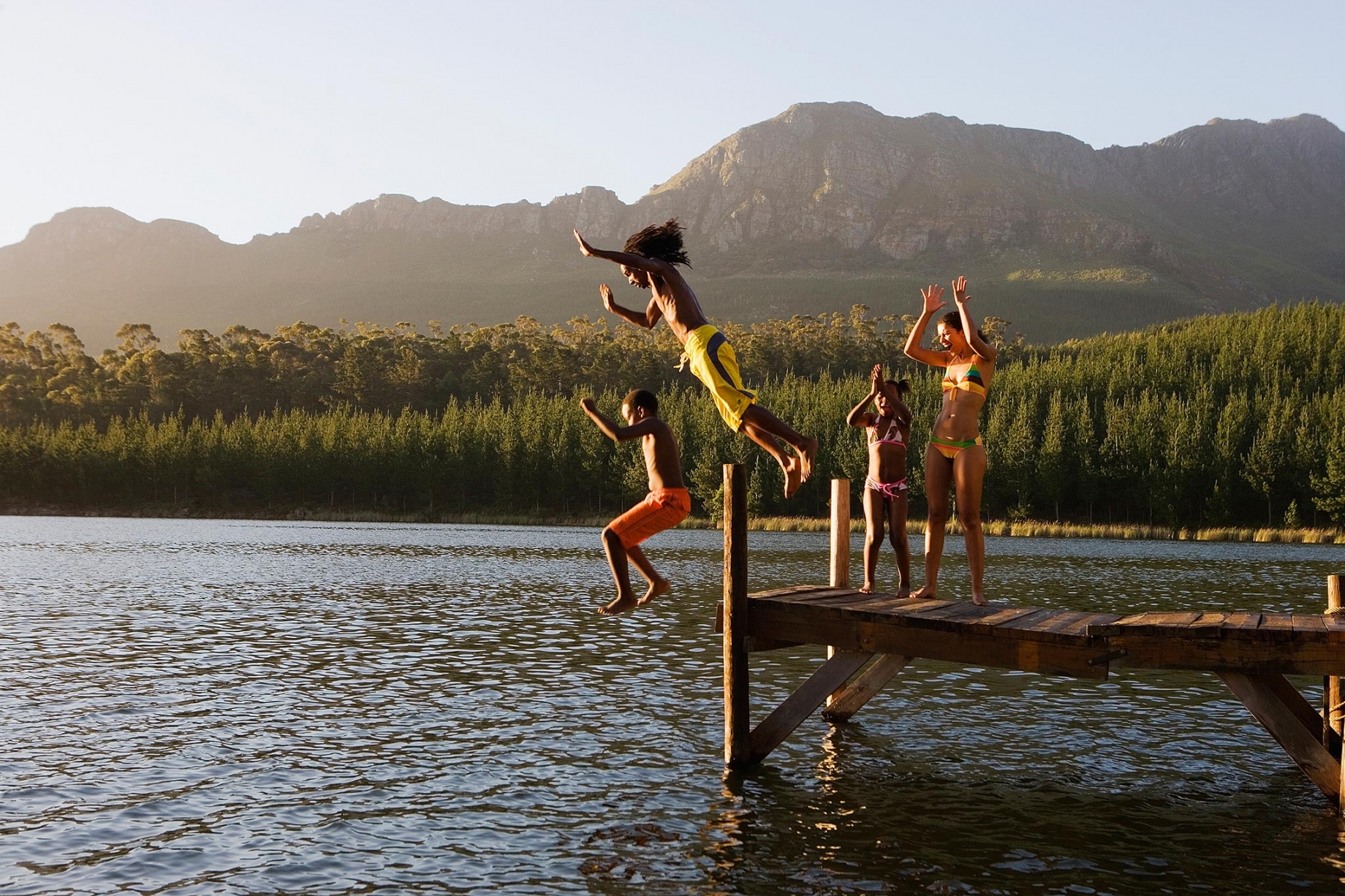 Family jumping in lake
